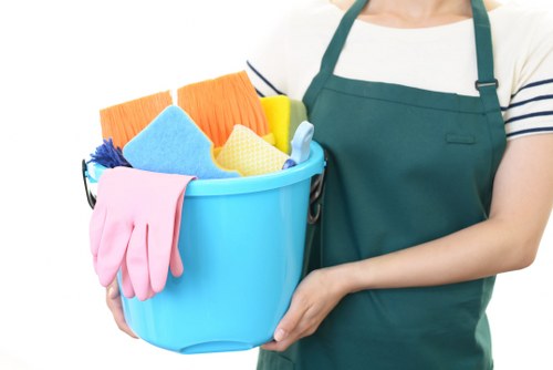 Cleaner in protective gear carrying out a safe cleaning task