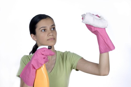 Cleaner organizing a tidy kitchen for a Wandsworth property